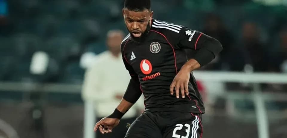 Player in black jersey dribbling the ball on field