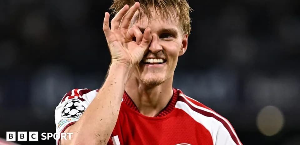 Player celebrating with a hand gesture in jersey