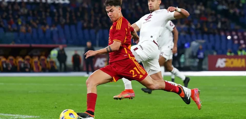 AS Roma player dribbling past Torino defender
