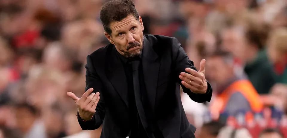 Manager gesturing during a match on the sideline
