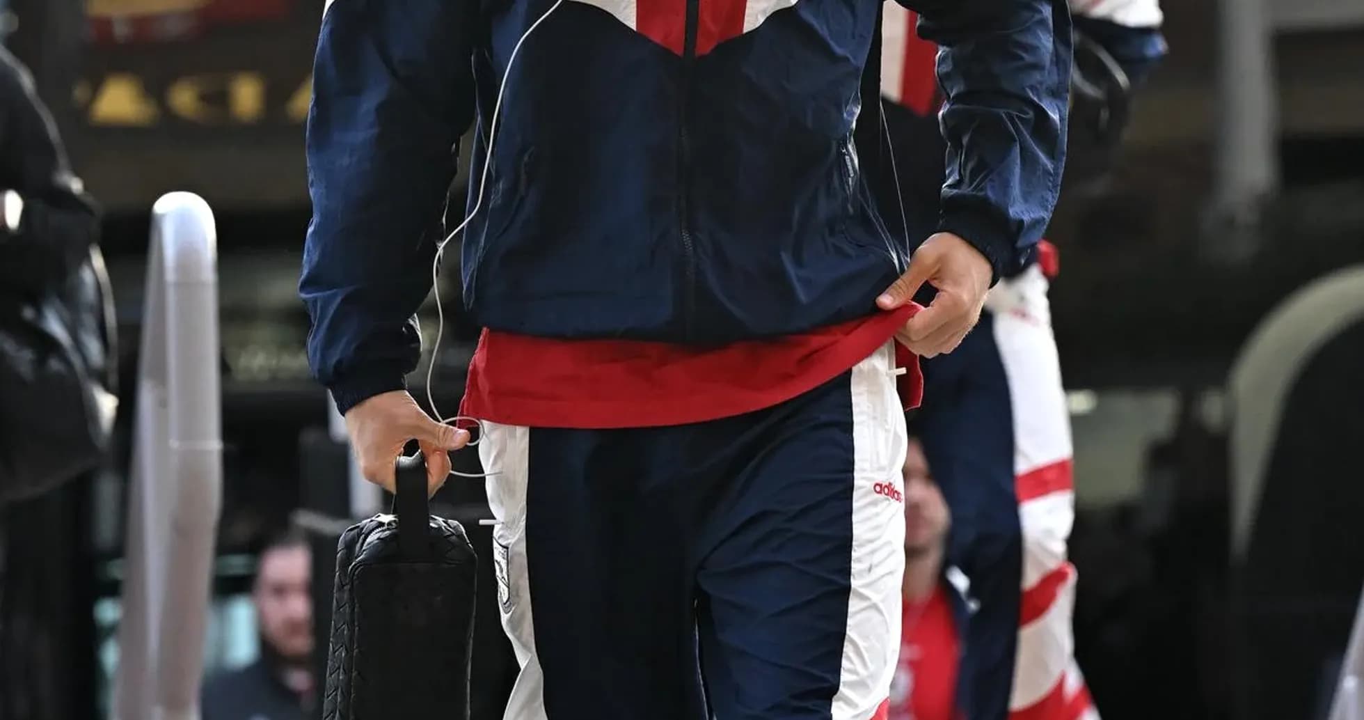 Player arriving in team tracksuit before match