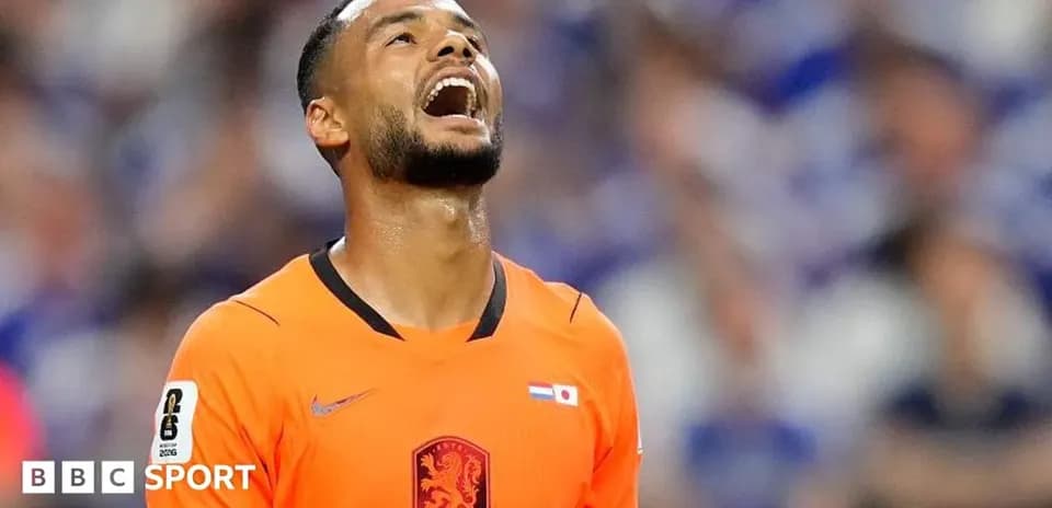 Player in orange jersey looking up in frustration