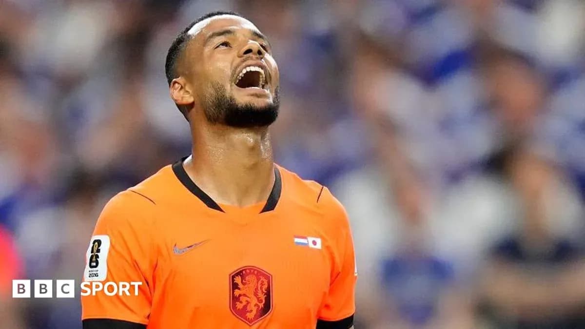 Player in orange jersey looking up in frustration