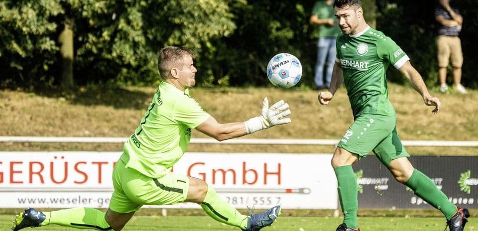 Goalkeeper attempting to catch the ball