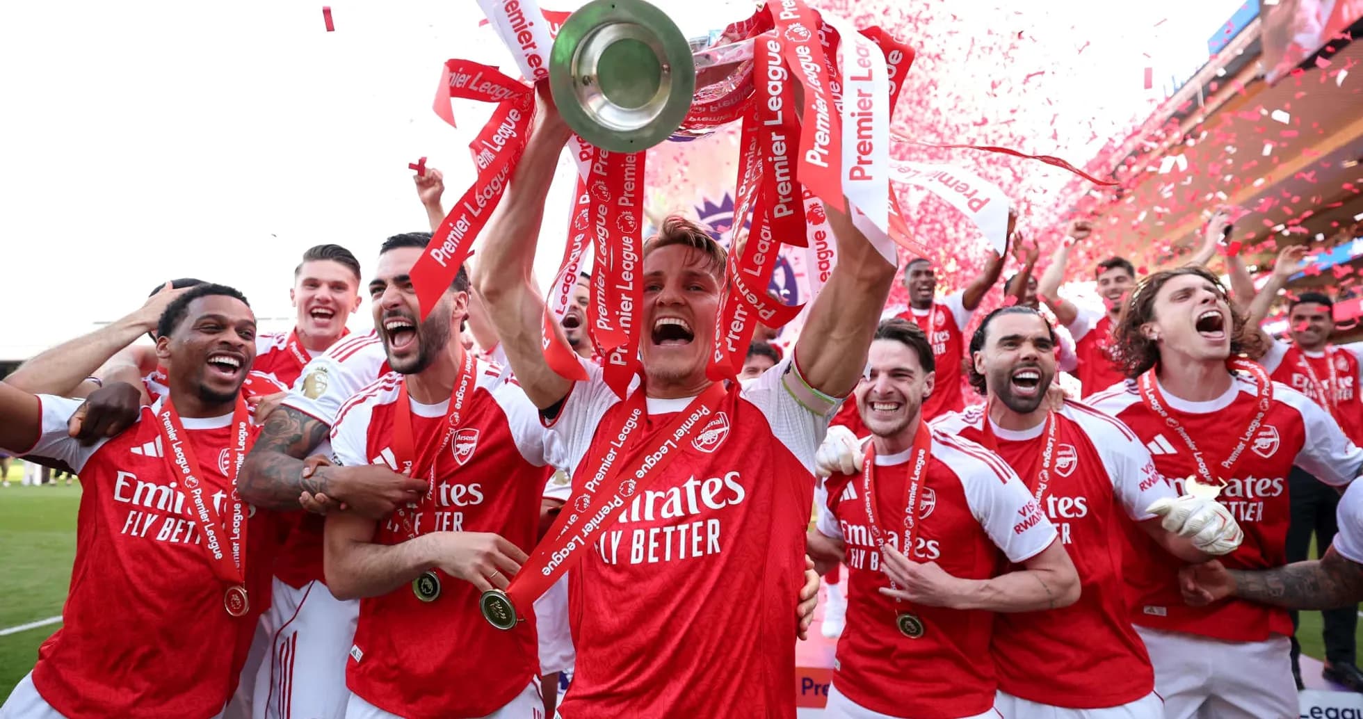 Arsenal players celebrating Premier League victory with trophy