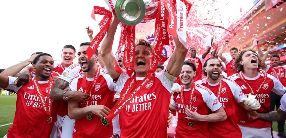 Arsenal players celebrating Premier League victory with trophy