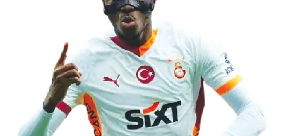 Player celebrating goal wearing protective mask