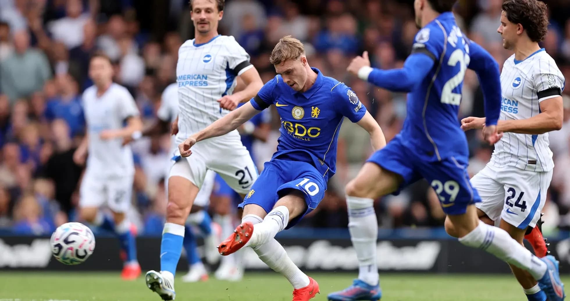 Chelsea player shooting against Brighton defenders