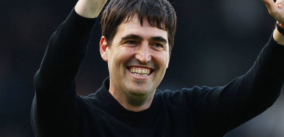 Coach celebrating with raised hand after match