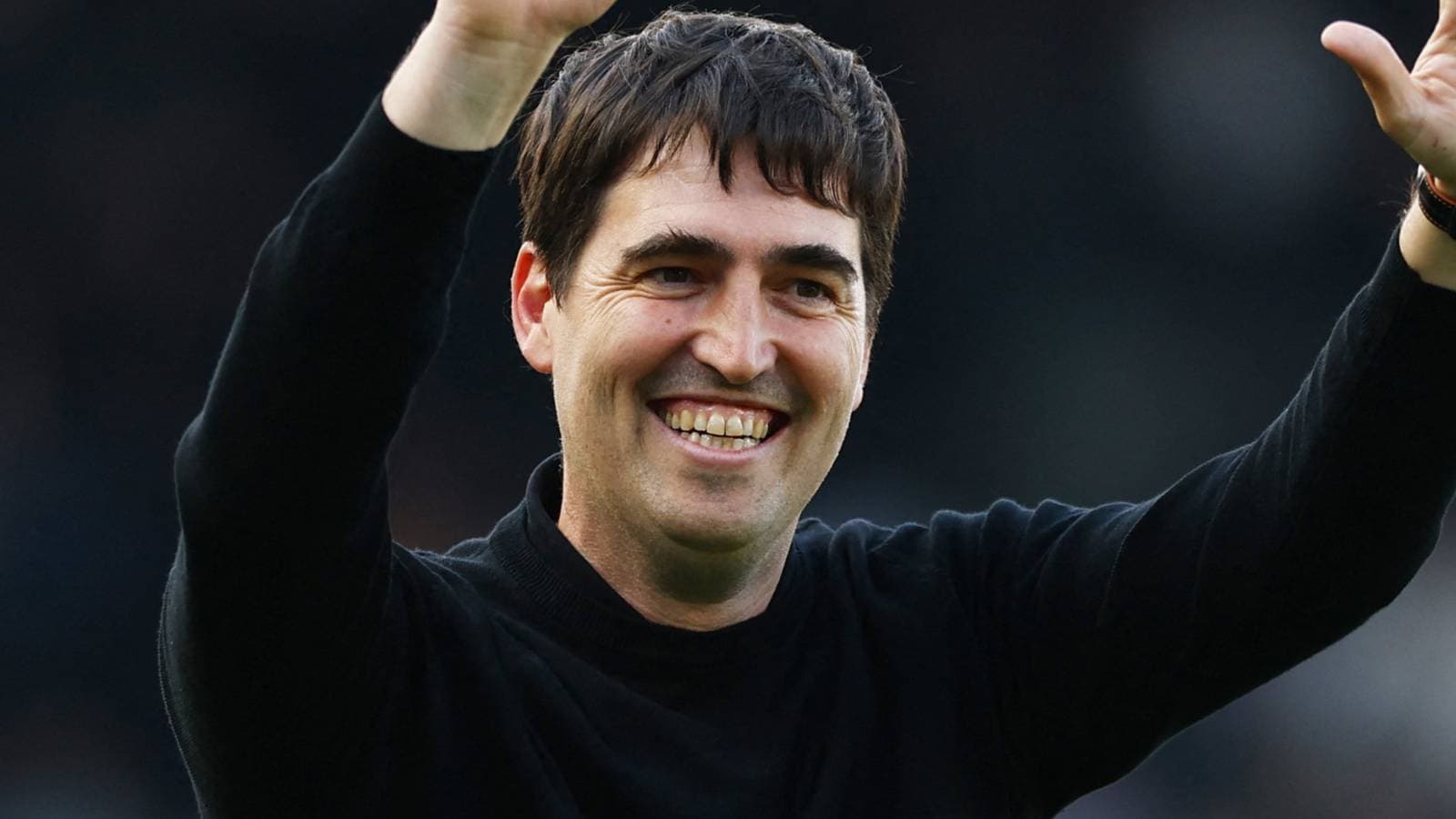 Coach celebrating with raised hand after match