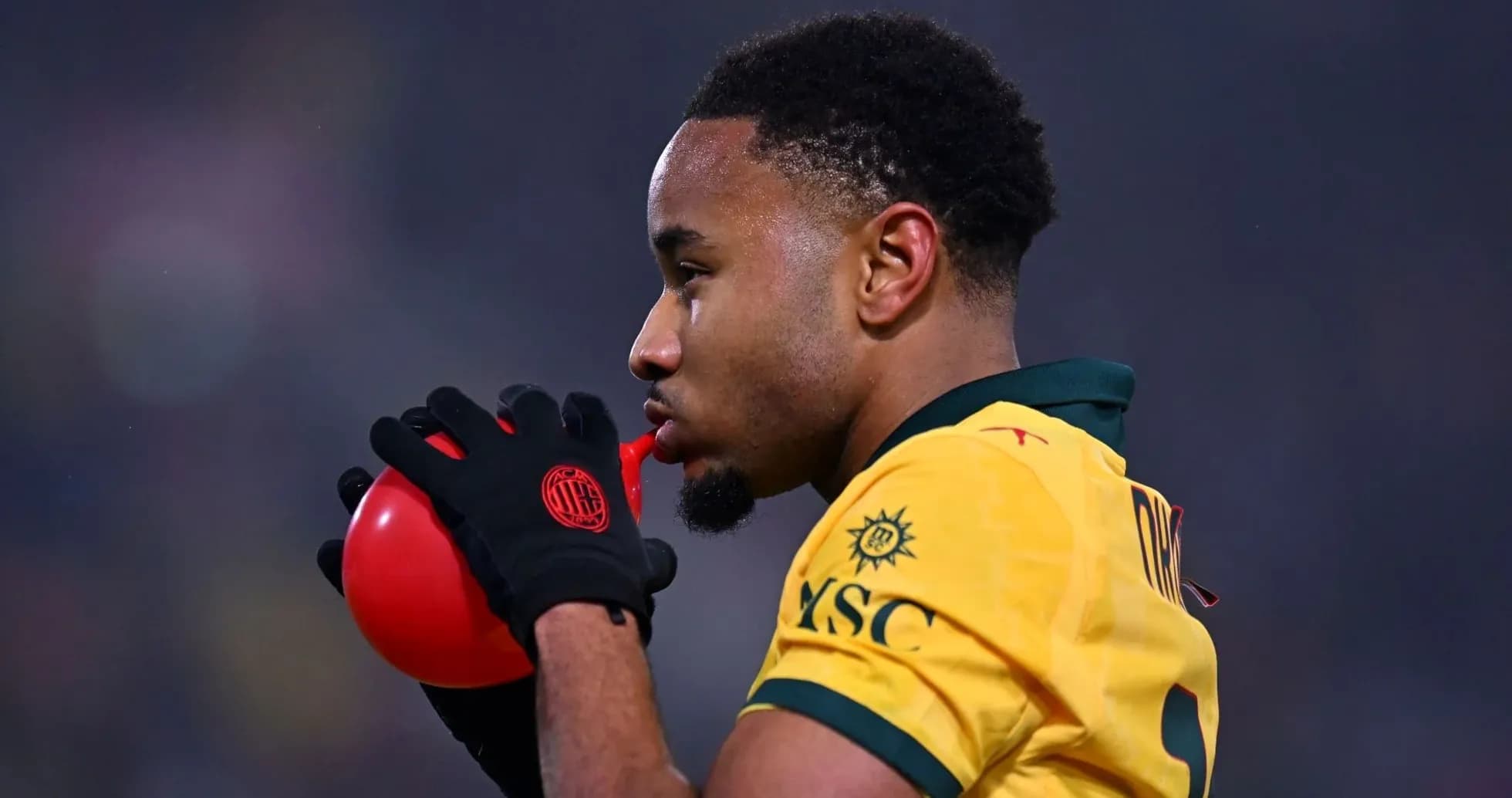 Player blowing into a red whistle during match