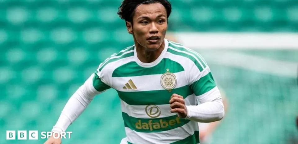 Player running during a match wearing Celtic jersey