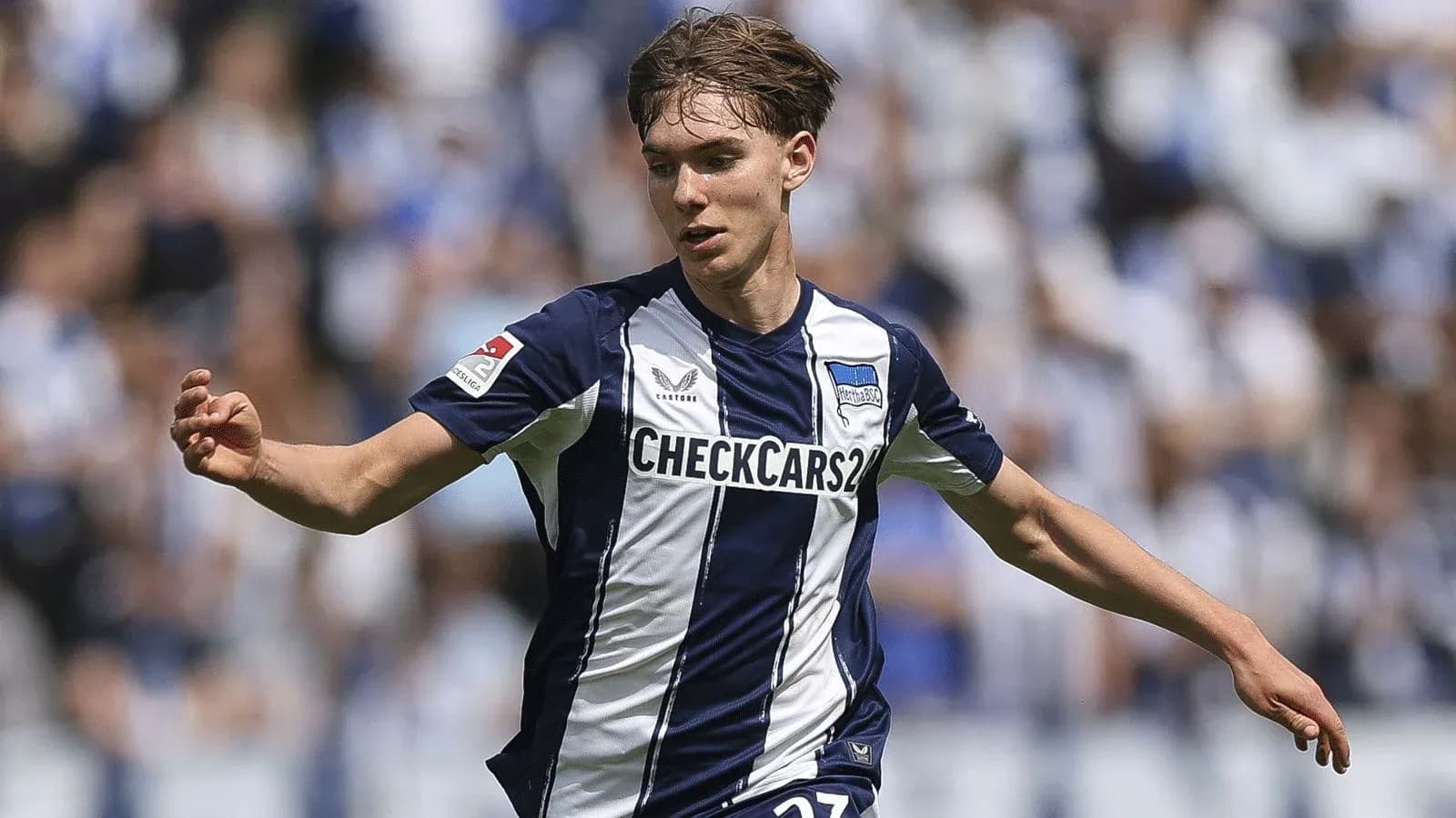Player running with ball during match for Hertha BSC
