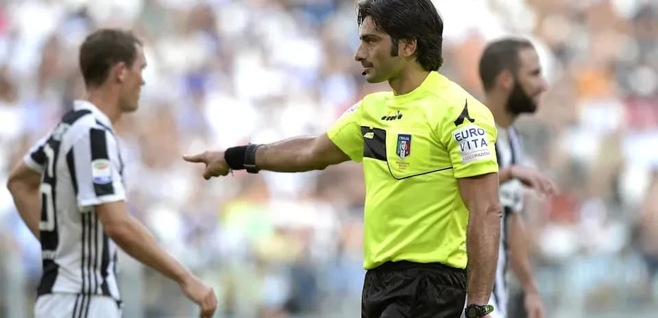 Referee gesturing to player during a match