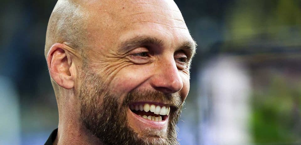 Man smiling during a press conference