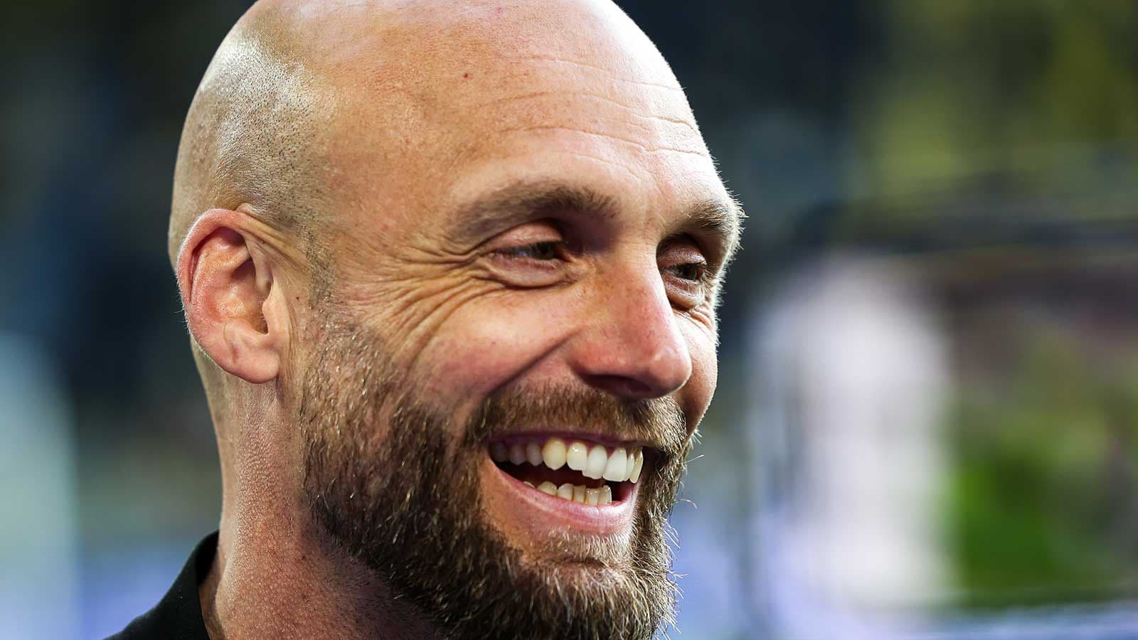 Man smiling during a press conference