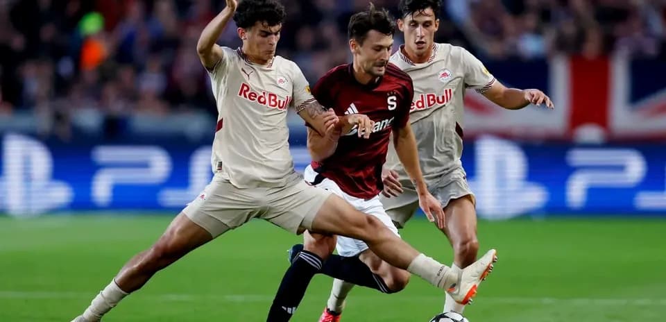 Players contesting for the ball in UEFA match