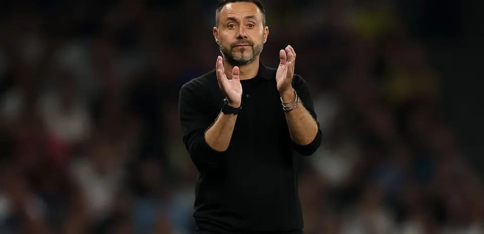 Coach clapping during a football match