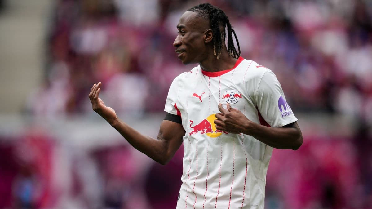 Player gesturing during match wearing RB Leipzig kit