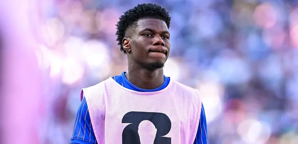 Player in training bib on the sidelines