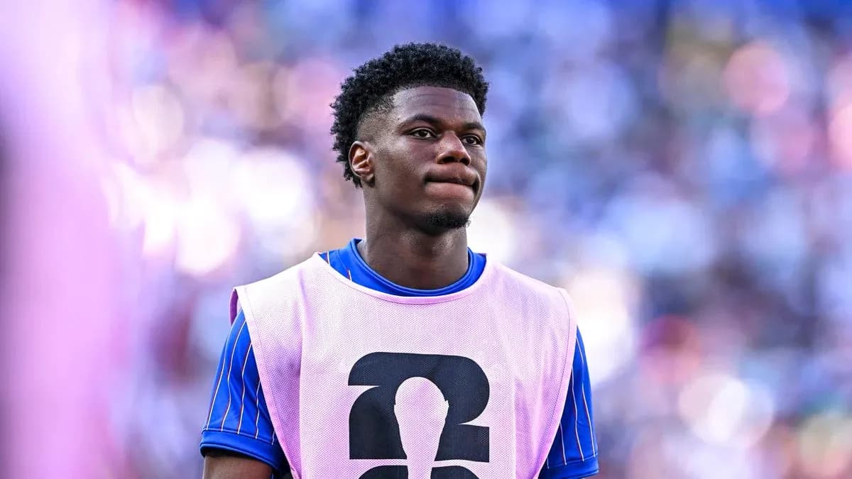 Player in training bib on the sidelines