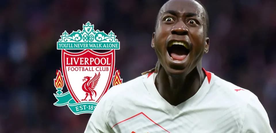 Player celebrating in front of Liverpool logo