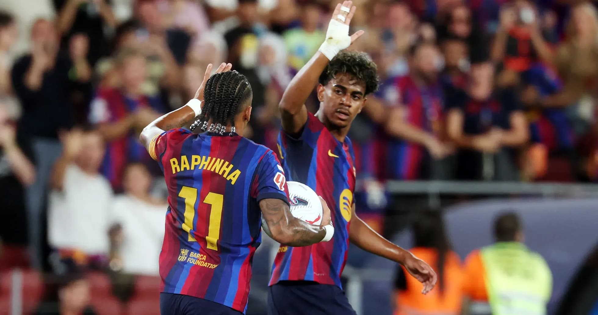 Raphinha celebrating with teammate during match