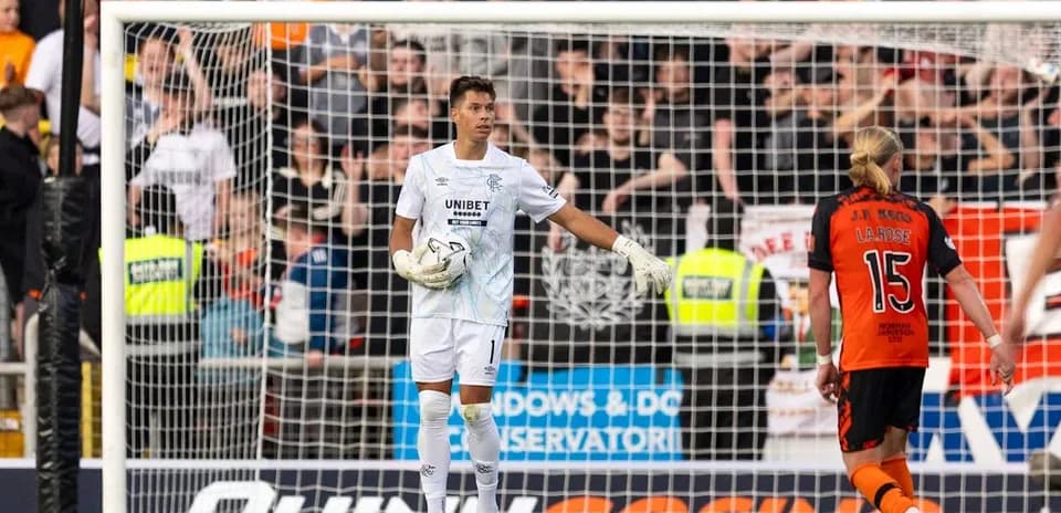 Goalkeeper in white kit during match action