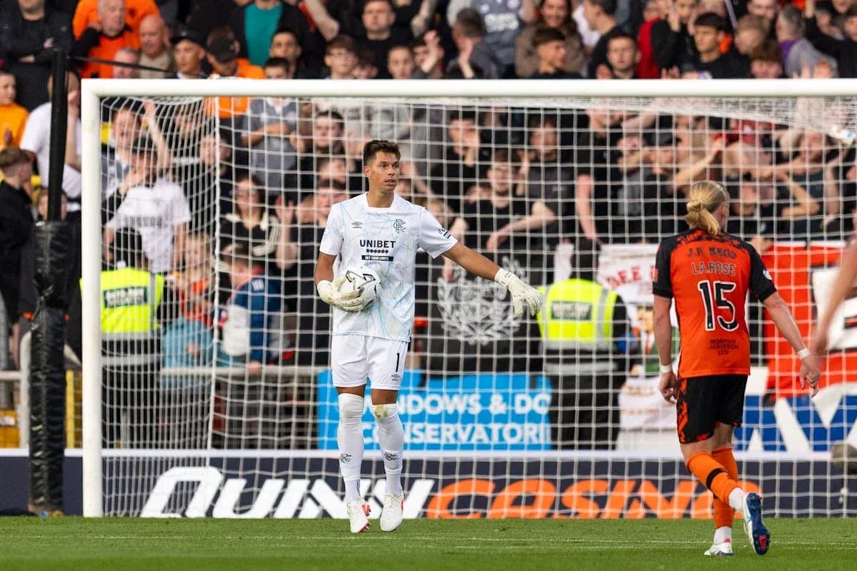 Goalkeeper in white kit during match action
