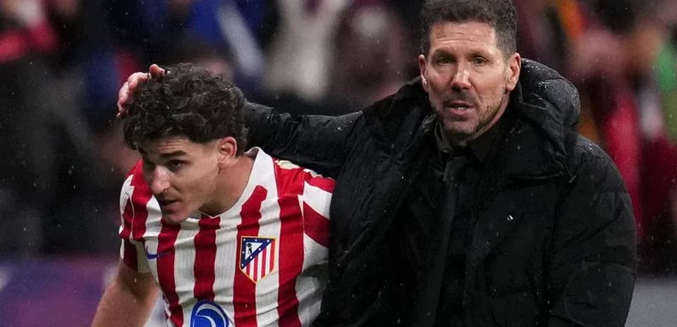 Atletico Madrid player assisted by coach during match