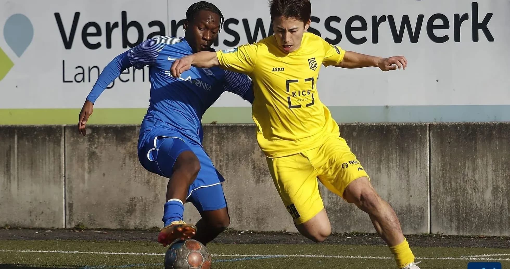 Players competing for the ball in football match
