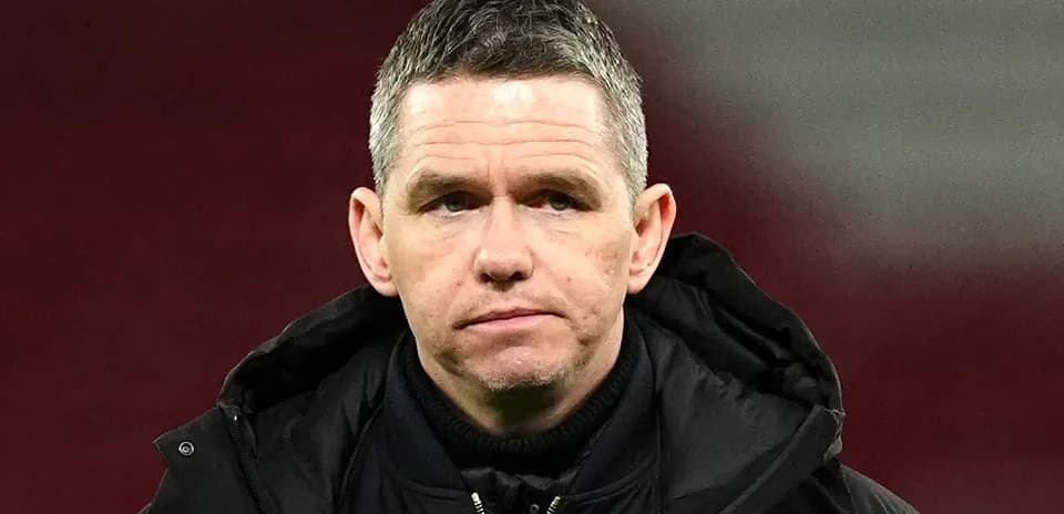 Coach observing during a match on the sidelines