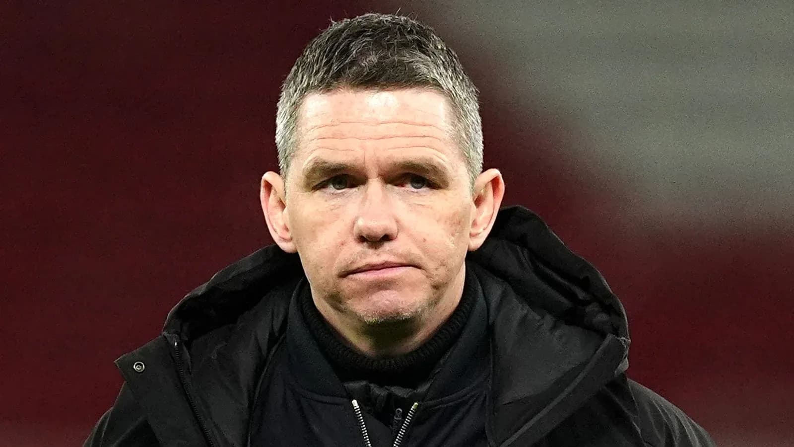 Coach observing during a match on the sidelines