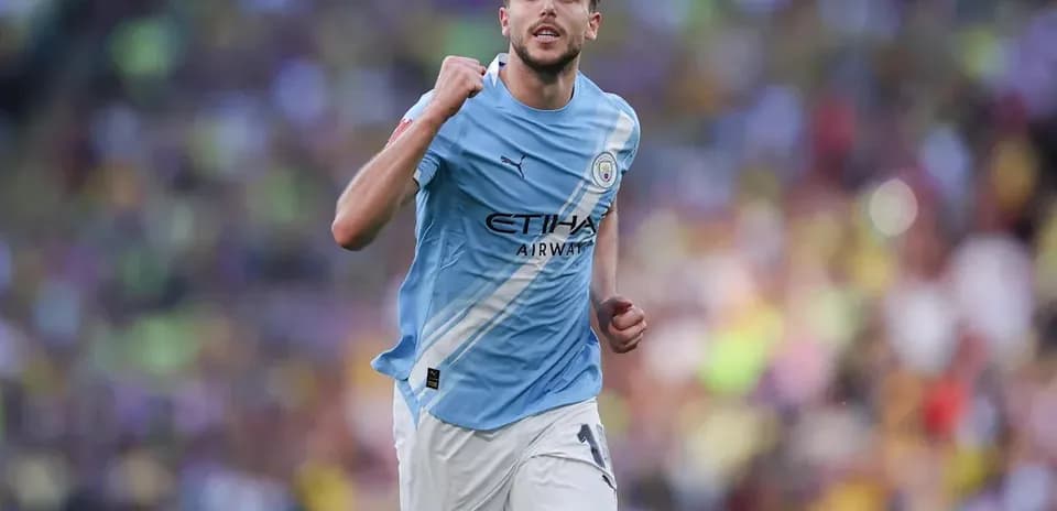 Player celebrating during match wearing Manchester City kit