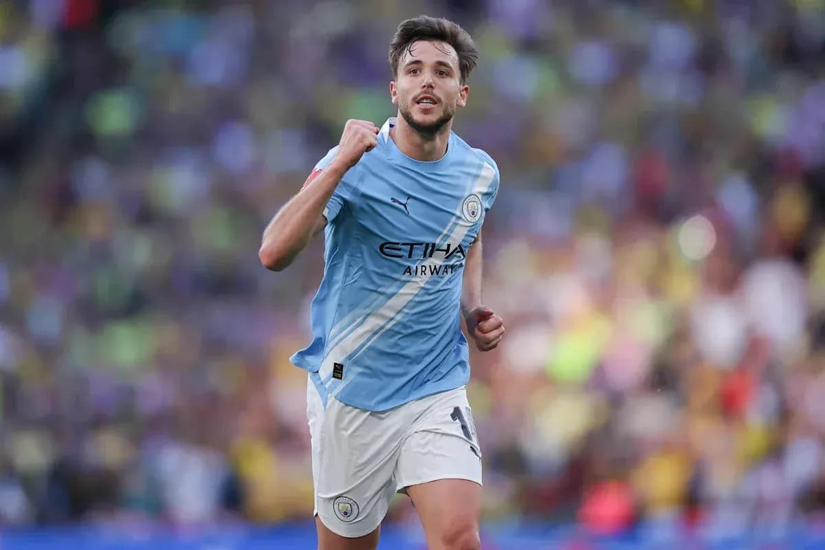 Player celebrating during match wearing Manchester City kit