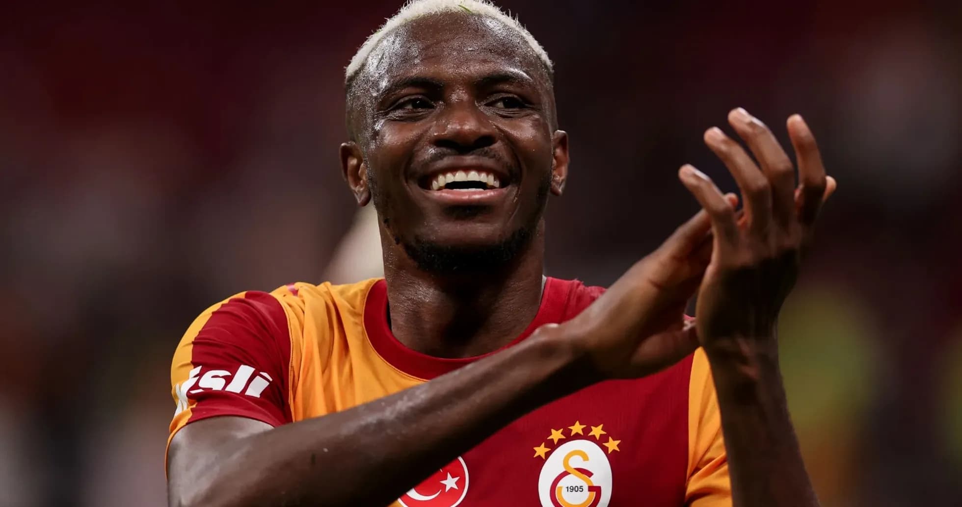 Player celebrating in Galatasaray jersey after match