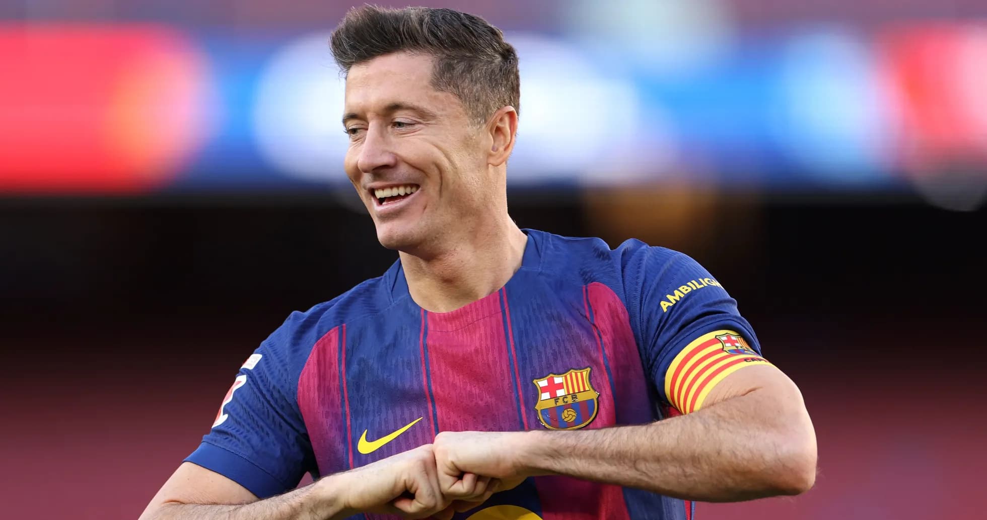 Player in Barcelona jersey smiling on the pitch