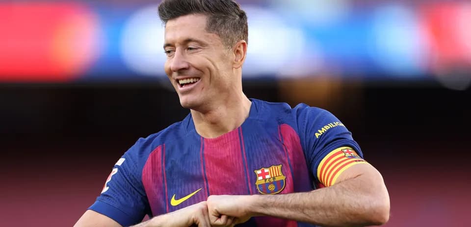 Player in Barcelona jersey smiling on the pitch