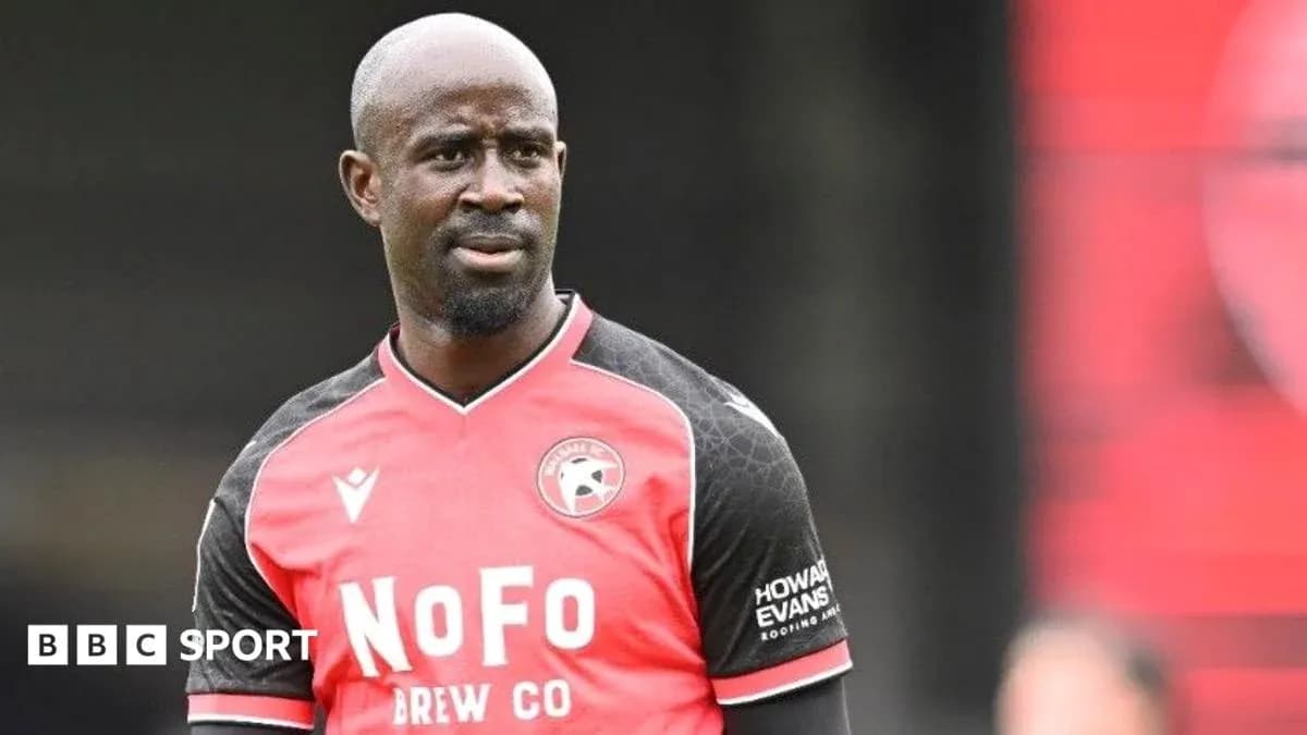 Player in red and black jersey during match