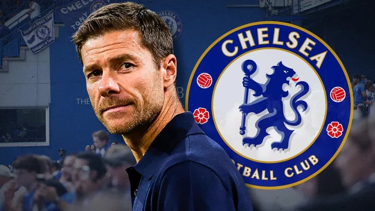 Coach in front of Chelsea FC logo and fans