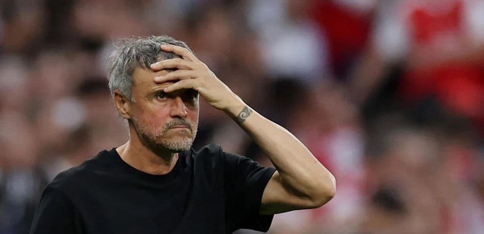 Coach with hand on forehead during match