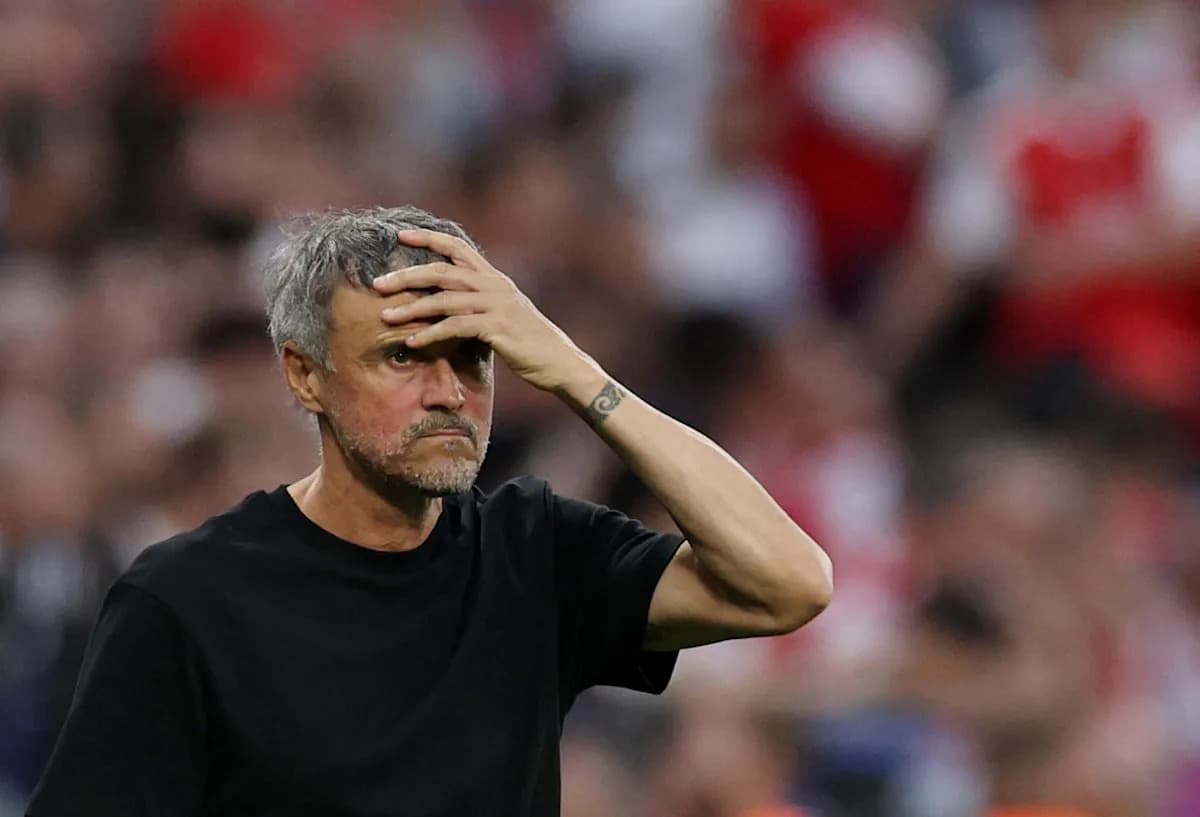 Coach with hand on forehead during match