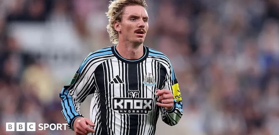 Player running on field in Newcastle kit