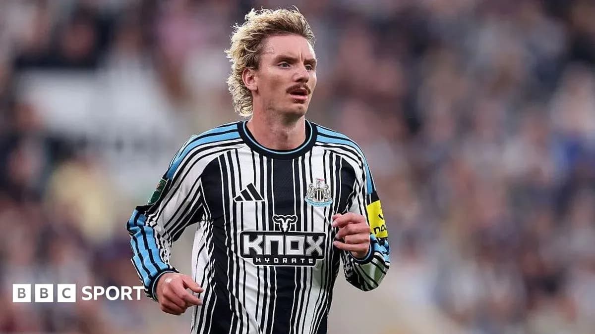 Player running on field in Newcastle kit