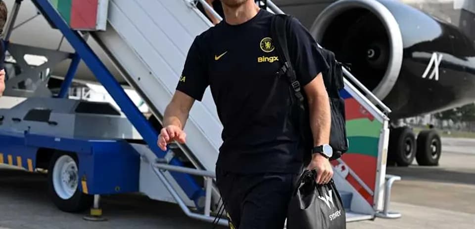 Coach walking towards airport terminal from plane
