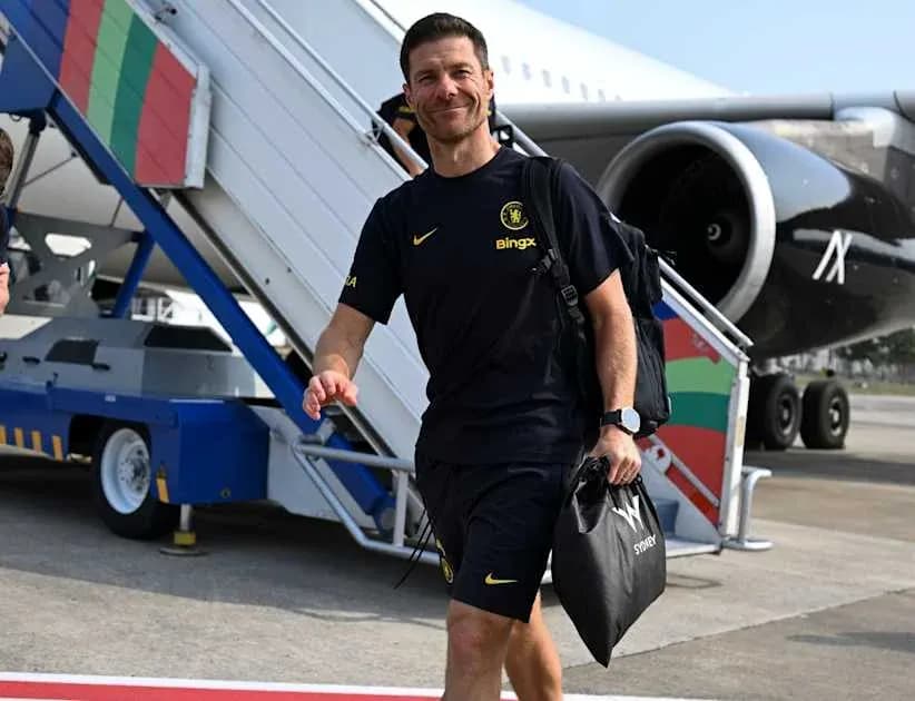 Coach walking towards airport terminal from plane