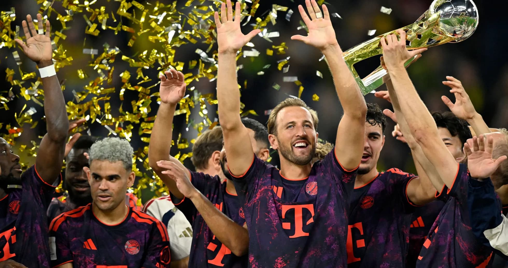 Bayern Munich players celebrating with trophy and confetti