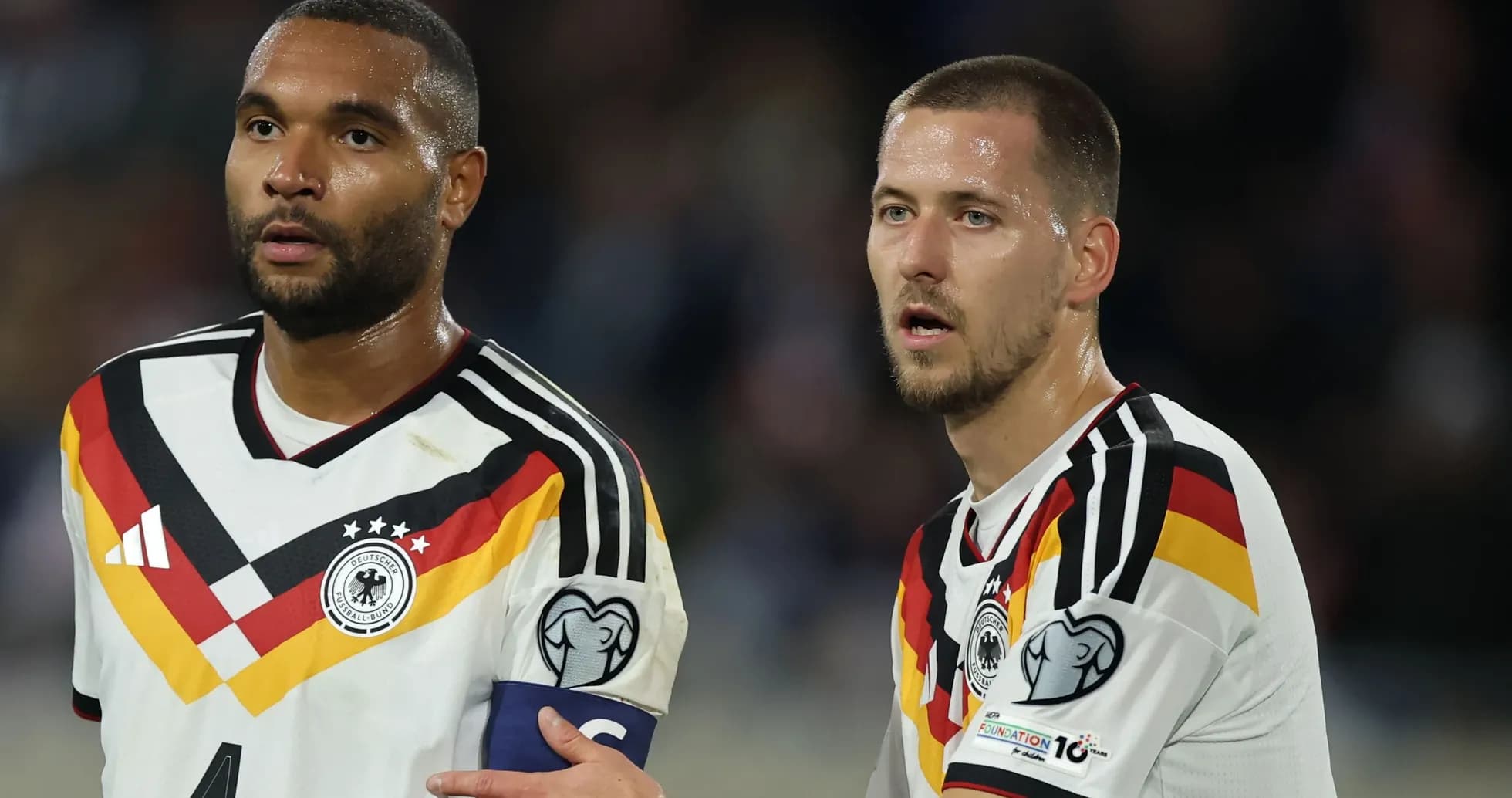 Two German players discussing during a match