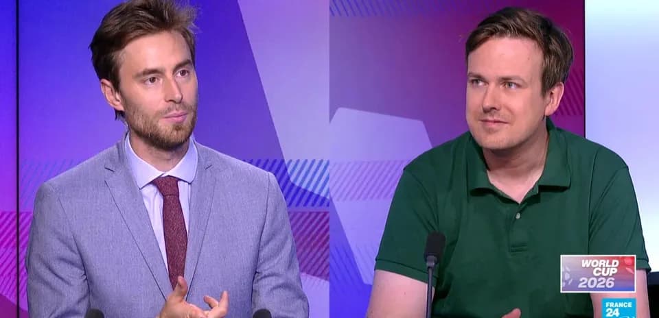 Two analysts discussing World Cup 2026 on set