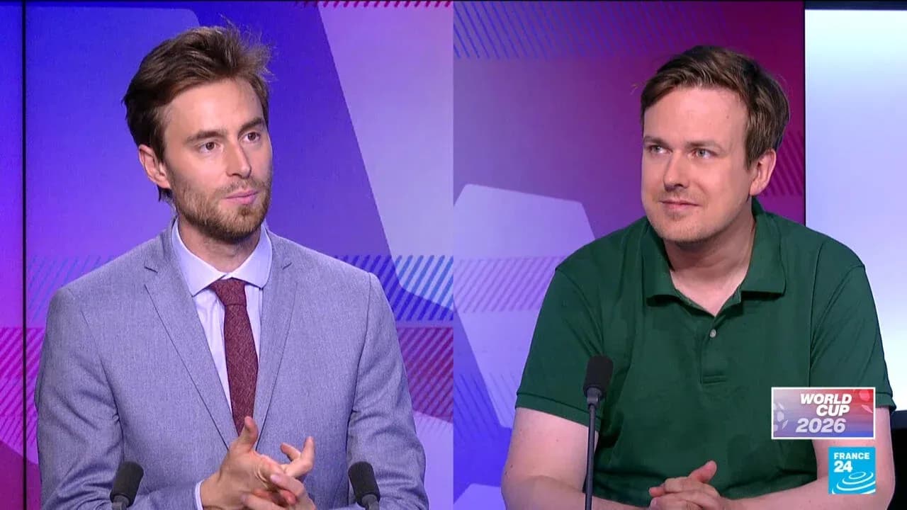 Two analysts discussing World Cup 2026 on set